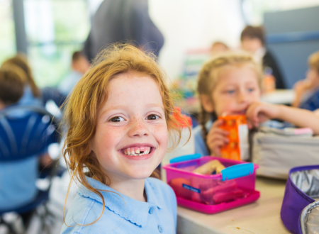 Child smiling at lunch
