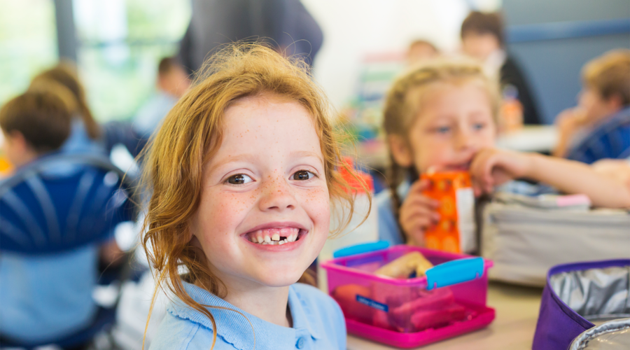 Child smiling at lunch