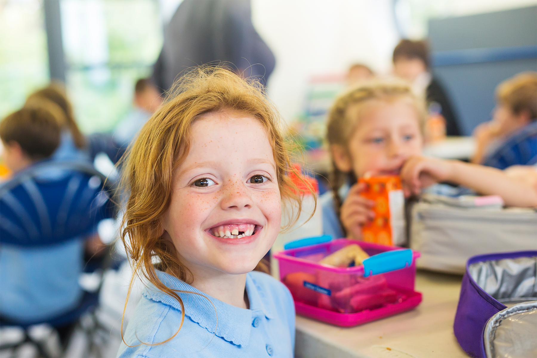 Child smiling at lunch