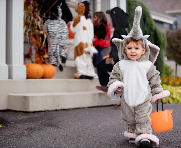 Child in Halloween costume trick or treating