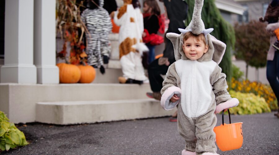 Child in Halloween costume trick or treating